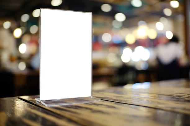 istock Mock up Menu frame standing on wood table in Bar restaurant cafe. space for text 961705984