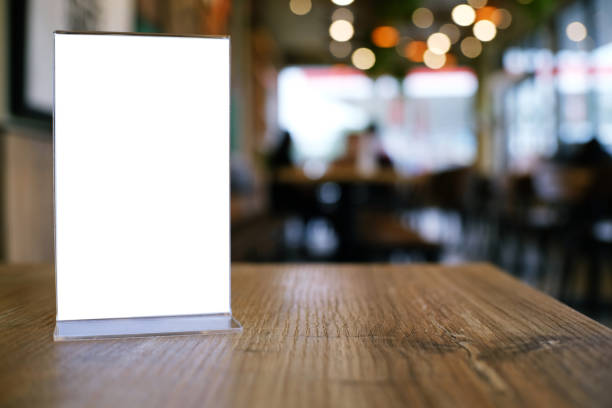 istock Mock up Menu frame standing on wood table in Bar restaurant cafe. space for text 961706336