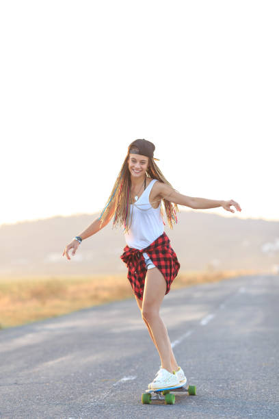istock Smiling skater moving down on country road 961709012