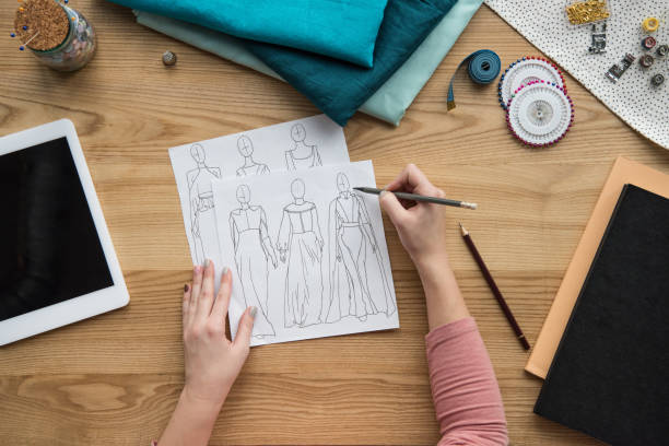 istock top view of cropped female hands drawing draft at seamstress workplace 961709212