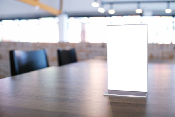 istock Mock up Menu frame standing on wood table in Bar restaurant cafe. space for text 961709656