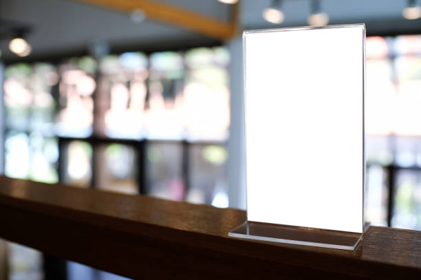 istock Mock up Menu frame standing on wood table in Bar restaurant cafe. space for text 961709880