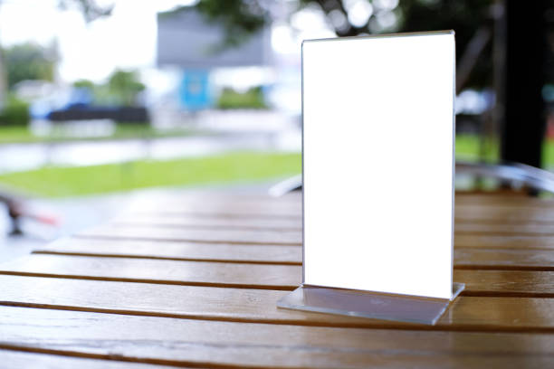 istock Mock up Menu frame standing on wood table in Bar restaurant cafe. space for text 961710048