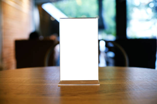 istock Mock up Menu frame standing on wood table in Bar restaurant cafe. space for text 961710058