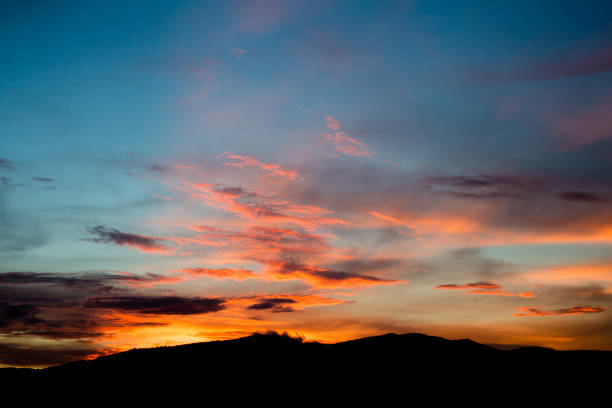 istock Beautiful sunset with red Clouds and sunray like flame on the sky over mountain. 961710136