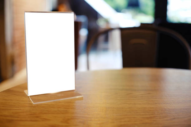 istock Mock up Menu frame standing on wood table in Bar restaurant cafe. space for text 961710148