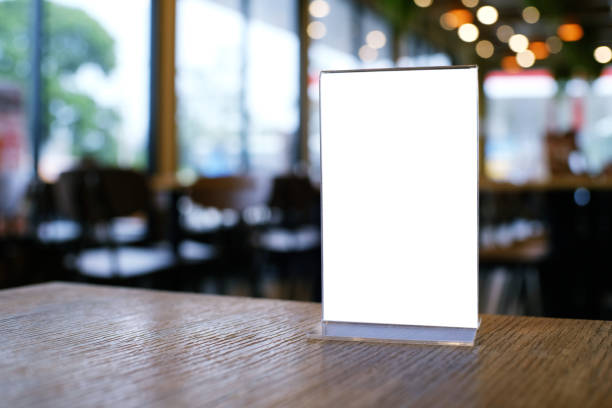 istock Mock up Menu frame standing on wood table in Bar restaurant cafe. space for text 961710152
