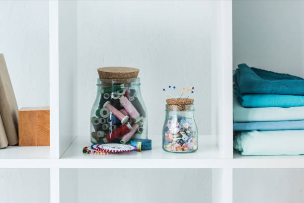 istock pile of folded colored fabric with stitchings in bottles on white shelf 961712954