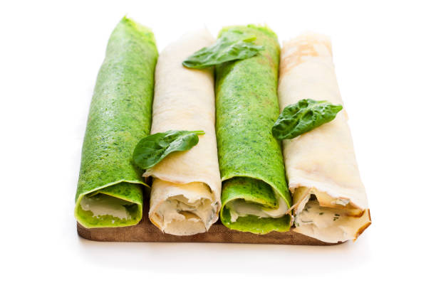 istock Rolled  milk and spinach pancakes isolated on white 961713956