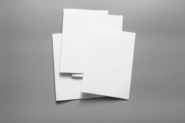 istock Blank portrait mock-up paper. brochure magazine isolated on grey, changeable background / white paper isolated on grey 961714444