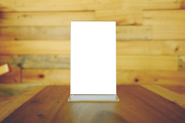 istock Mock up Menu frame standing on wood table in Bar restaurant cafe. space for text 961714594