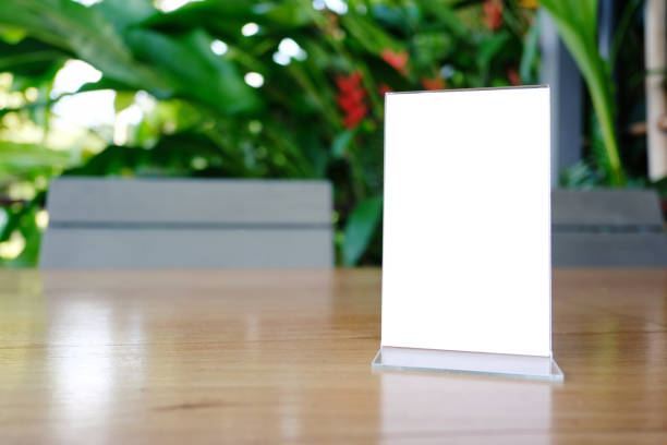 istock Mock up Menu frame standing on wood table in Bar restaurant cafe. space for text 961714644