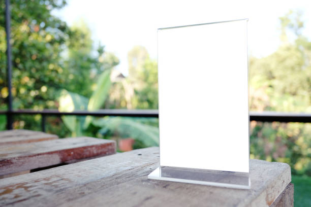 istock Mock up Menu frame standing on wood table in Bar restaurant cafe. space for text 961714724