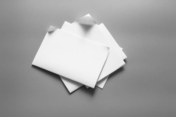 istock Blank portrait mock-up paper. brochure magazine isolated on grey, changeable background / white paper isolated on grey 961714756