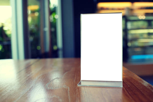 istock Mock up Menu frame standing on wood table in Bar restaurant cafe. space for text 961714810