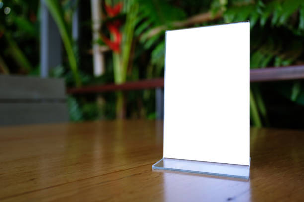 istock Mock up Menu frame standing on wood table in Bar restaurant cafe. space for text 961714820