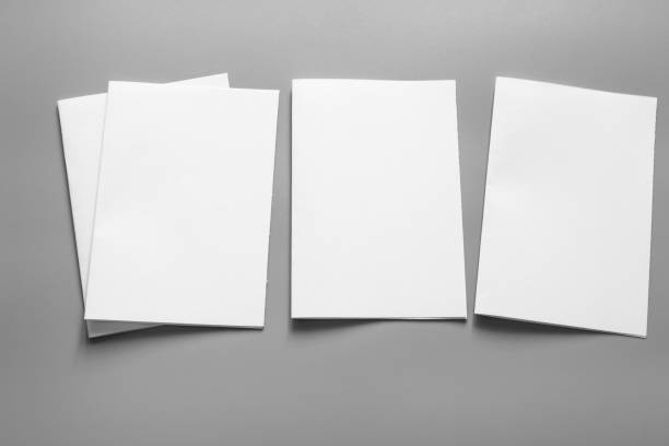 istock Blank portrait mock-up paper. brochure magazine isolated on grey, changeable background / white paper isolated on grey 961714984