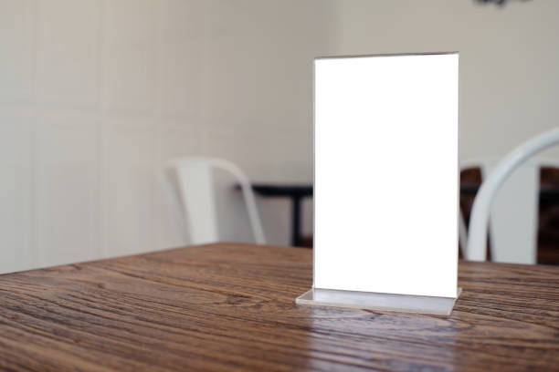 istock Mock up Menu frame standing on wood table in Bar restaurant cafe. space for text 961715218