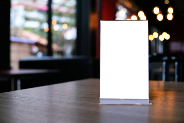 istock Mock up Menu frame standing on wood table in Bar restaurant cafe. space for text 961718388