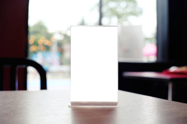 istock Mock up Menu frame standing on wood table in Bar restaurant cafe. space for text 961718398