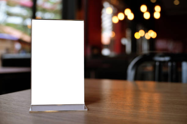 istock Mock up Menu frame standing on wood table in Bar restaurant cafe. space for text 961718402