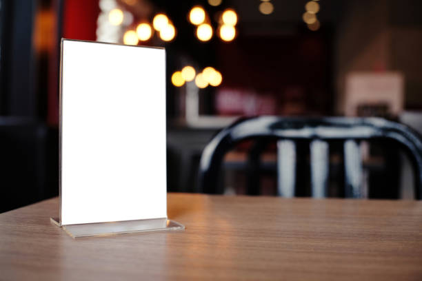 istock Mock up Menu frame standing on wood table in Bar restaurant cafe. space for text 961718430