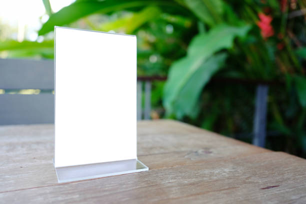 istock Mock up Menu frame standing on wood table in Bar restaurant cafe. space for text 961718632