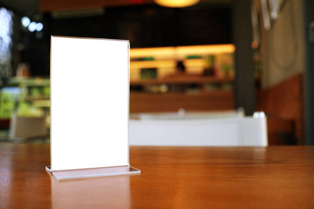 Mock up Menu frame standing on wood table in Bar restaurant cafe. space for text