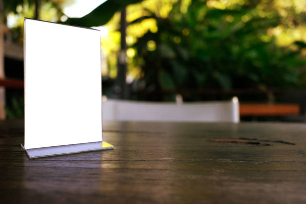 istock Mock up Menu frame standing on wood table in Bar restaurant cafe. space for text 961718684