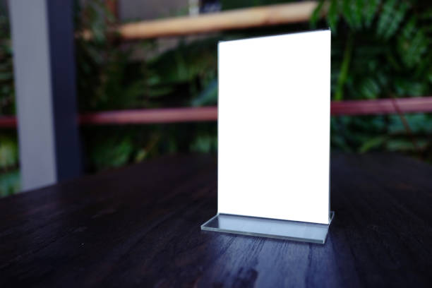istock Mock up Menu frame standing on wood table in Bar restaurant cafe. space for text 961718690
