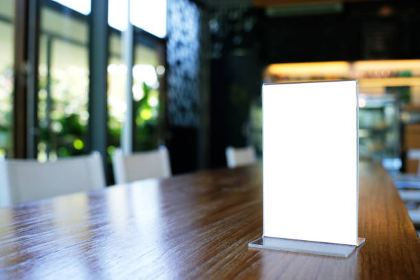 istock Mock up Menu frame standing on wood table in Bar restaurant cafe. space for text 961718762