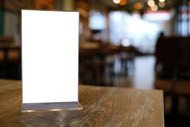 istock Mock up Menu frame standing on wood table in Bar restaurant cafe. space for text 961719048