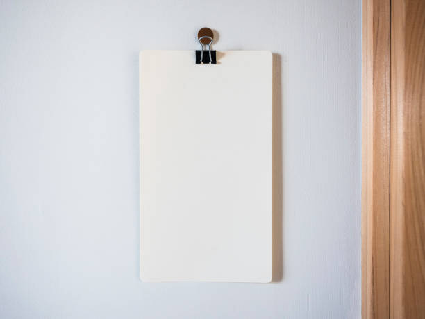 istock Blank Paper with paper clip hanging on wall 961720092