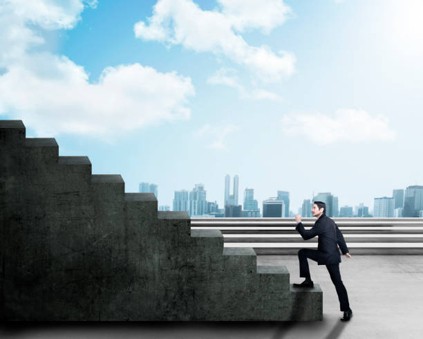 istock Young asian businessman stepping up a staircase 961720152