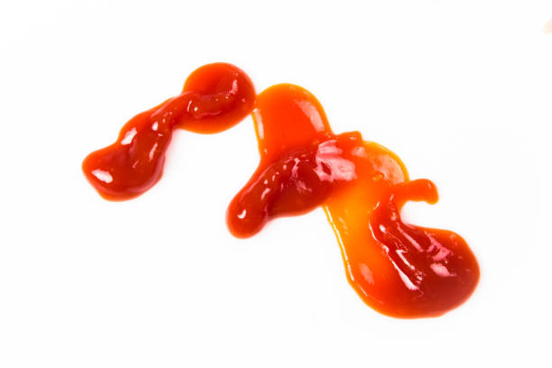 istock Tomato sauce isolated on white background. Red ketchup splashes isolated on white background, top view 961720430