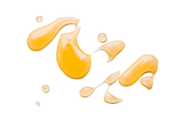 liquid honey isolated on white background - syrup imagens e fotografias de stock