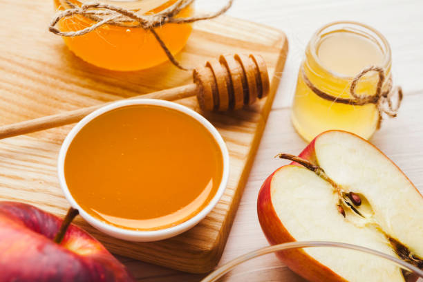 istock Apples and honey on white wooden planks 961721526