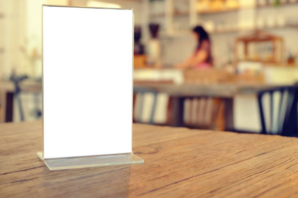 istock Mock up Menu frame standing on wood table in Bar restaurant cafe. space for text 961724548