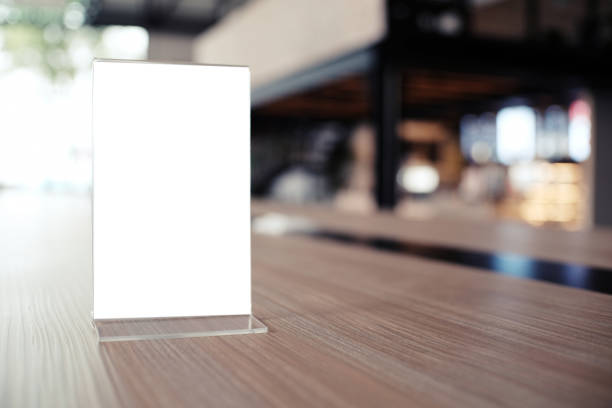 istock Mock up Menu frame standing on wood table in Bar restaurant cafe. space for text 961724550