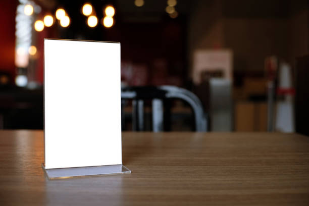 istock Mock up Menu frame standing on wood table in Bar restaurant cafe. space for text 961724792