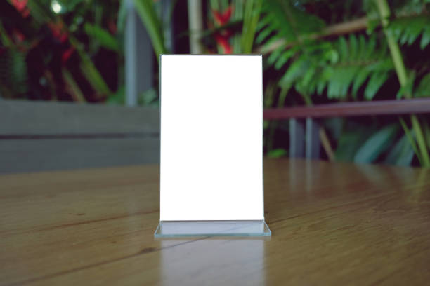 istock Mock up Menu frame standing on wood table in Bar restaurant cafe. space for text 961724880