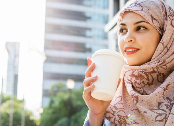istock Islamic woman drinking coffee in the city 961724948