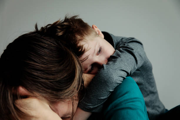 sad child with mother, family in sorrow stock photo