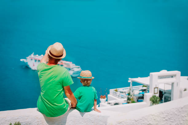 istock father and little son looking at Santorini, Greece 961725452