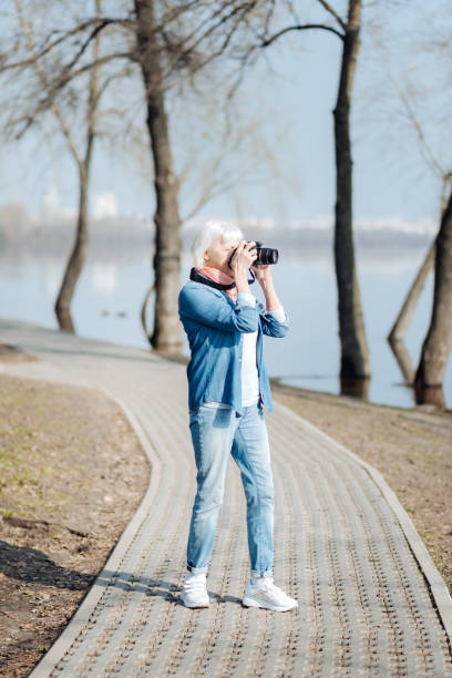istock Inspired woman taking photos in the park 961729548