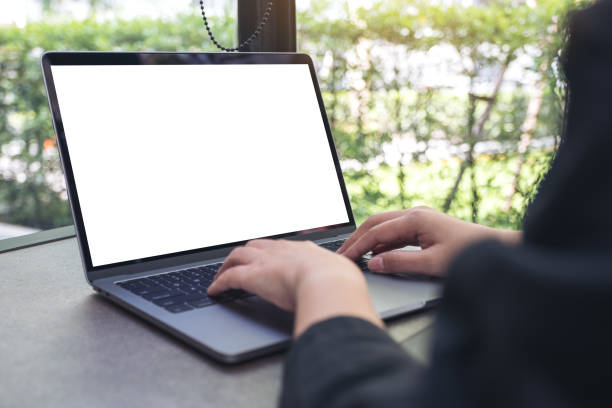istock a woman using and typing on laptop with blank white desktop screen 961730974