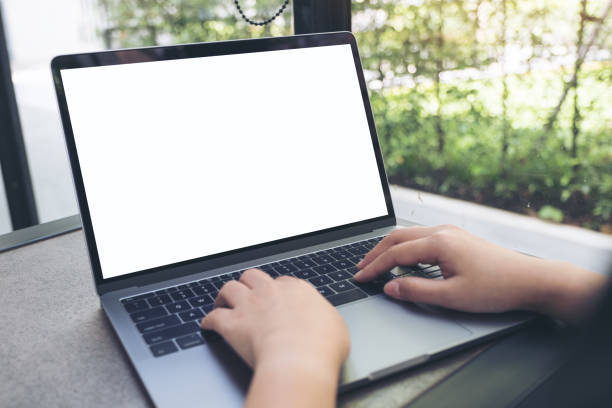 istock a woman using and typing on laptop with blank white desktop screen 961730988