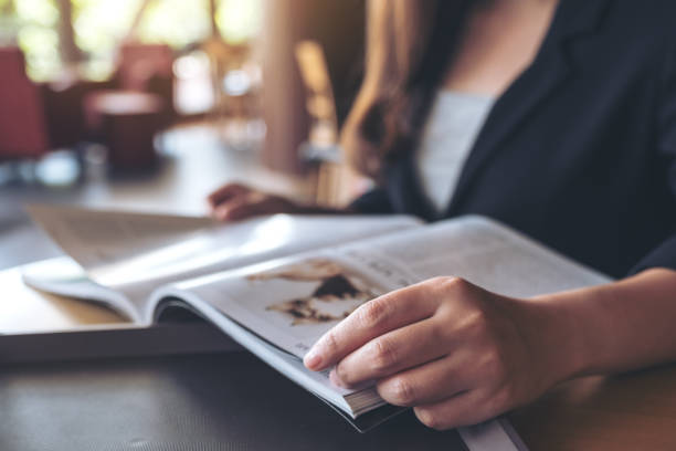 istock a business woman reading a book in modern cafe 961731232