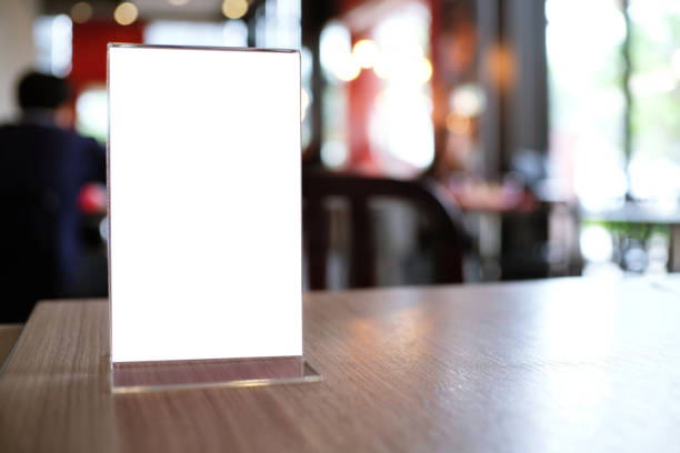 istock Mock up Menu frame standing on wood table in Bar restaurant cafe. space for text 961732674