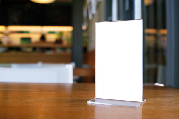 istock Mock up Menu frame standing on wood table in Bar restaurant cafe. space for text 961732834